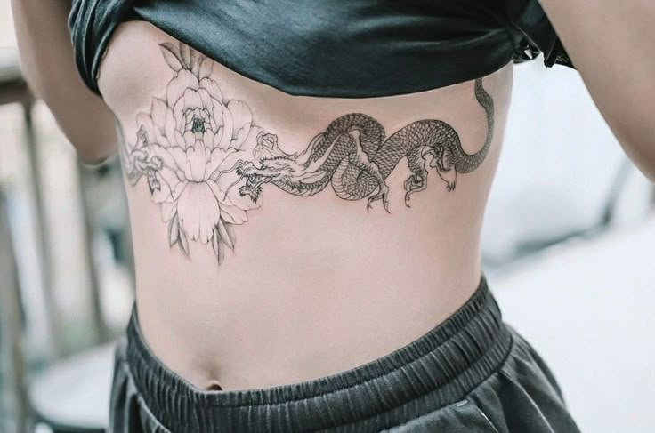 a woman with a dragon tattoo on her stomach