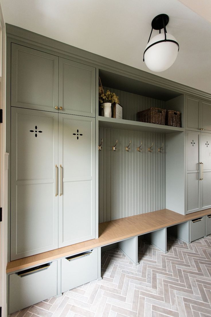 a room that has some cupboards and drawers in it with lights on the ceiling