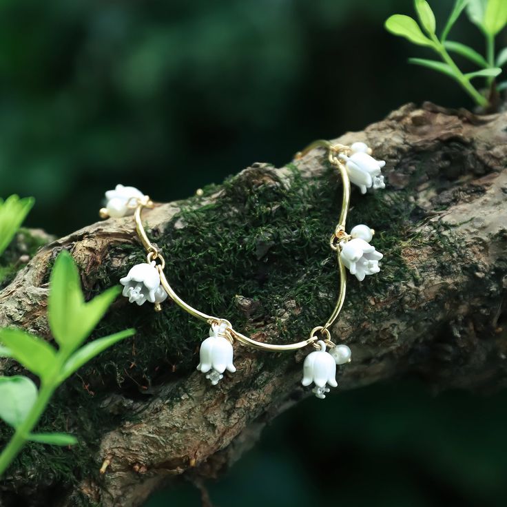 Inspired by the flowers of lily of the valley symbolizing good wishes and happiness, these little bell-shaped flowers earrings which grow in clusters are meant to be a good choose to give this exquisite Earrings to someone you love to wish them good luck and prosperity. The Lily Of The Valley Earrings Necklace is made of high-quality e namel   and 18k gold brass.   >> See   More  Lily of the Valley   Jewelry   Collection. DETAILS Materials:   18K Gold on Brass, Cubic Zirconia,  Enamel Size:  Len Lilly Of The Valley Jewelry, Lily Of The Valley Jewelry, Diamond Star Necklace, Star And Moon Necklace, Peach Earrings, Lily Of The Valley Flowers, Flowers Earrings, Good Wishes, Whimsical Jewelry