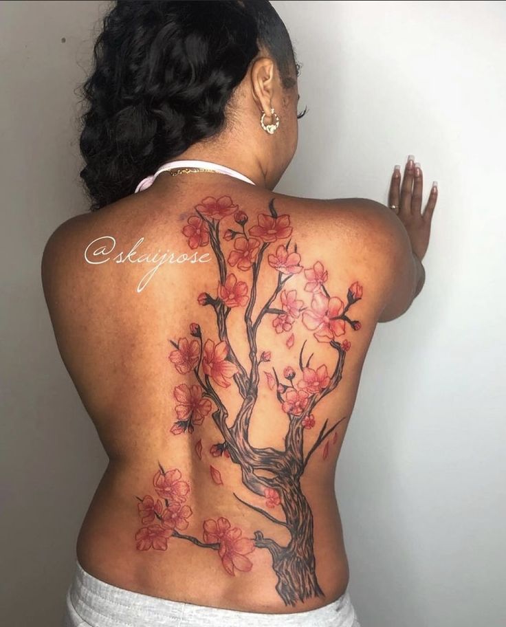 the back of a woman's body with flowers on it