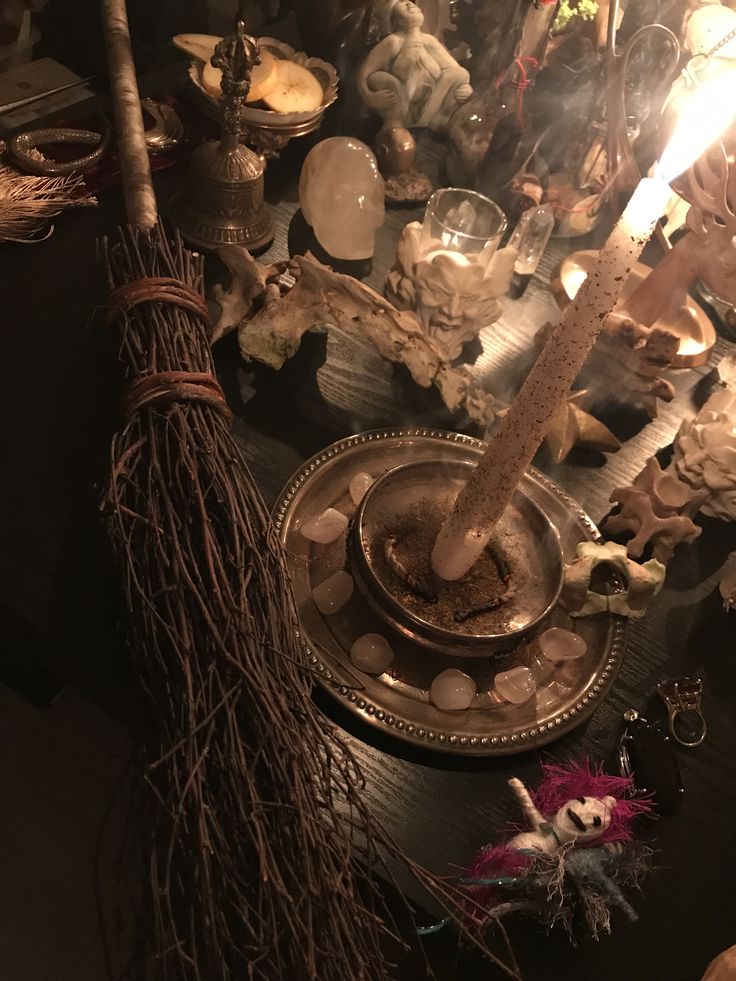 a table with candles, figurines and other items on it for halloween decor