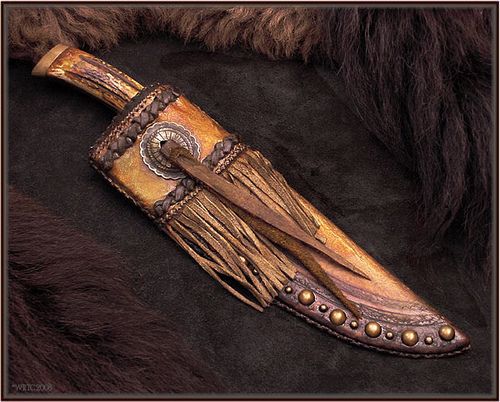 an animal's skin and leather sheath with metal rivets