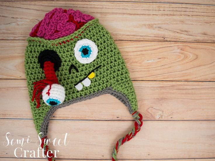 a crocheted hat with an eyeball on it