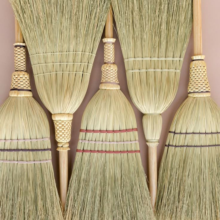 four brooms lined up next to each other