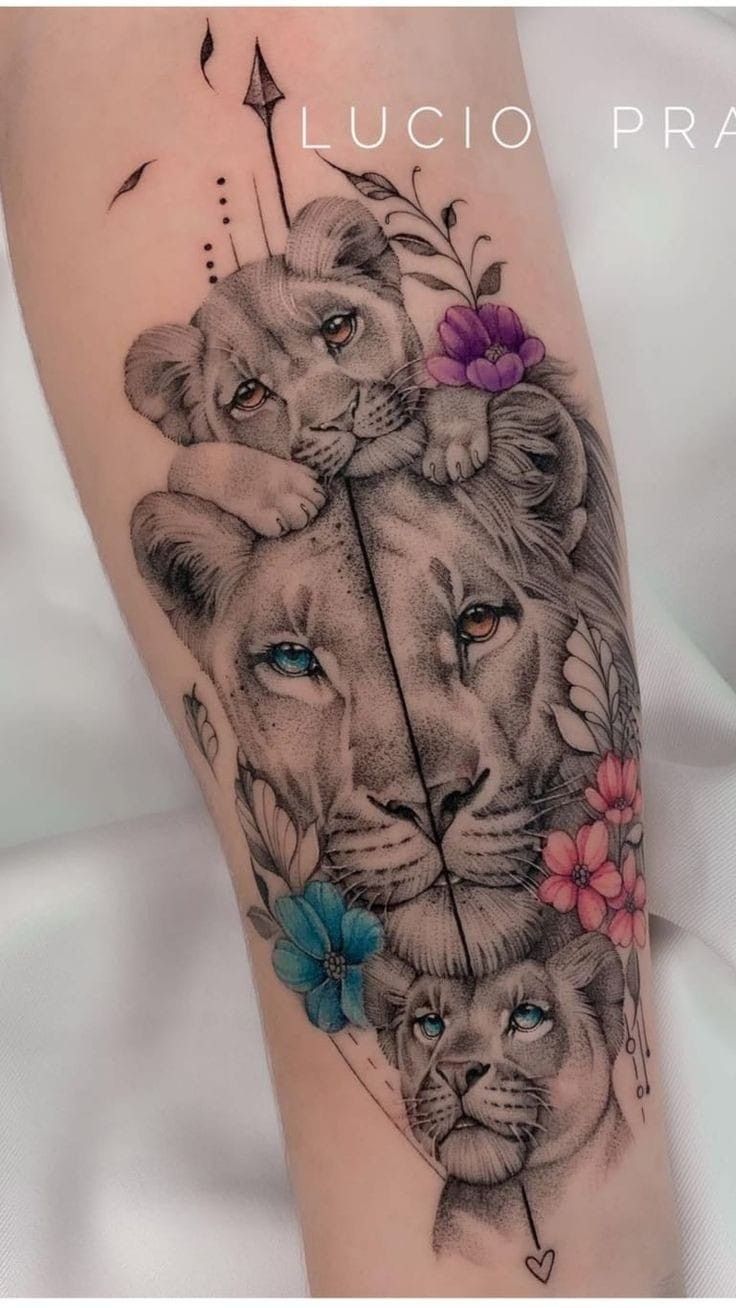 a tattoo with two lions and flowers on the leg, one is holding an arrow