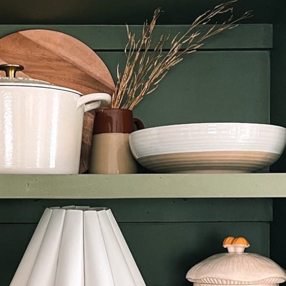 the shelves are filled with dishes and utensils