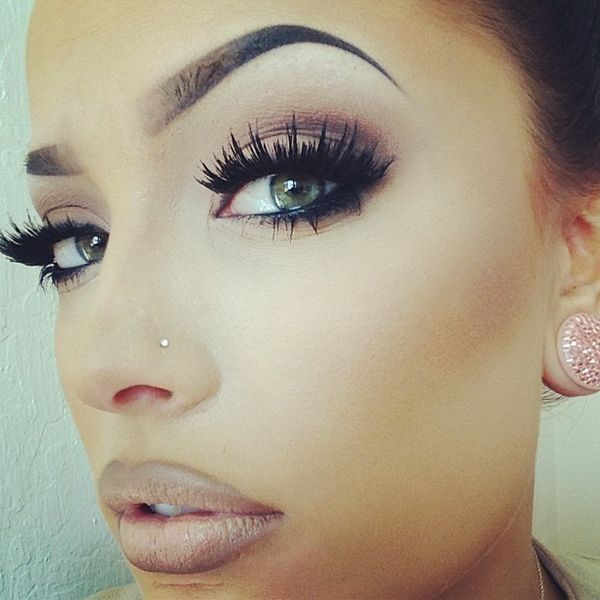 a close up of a woman with long lashes and eyeliners on her face