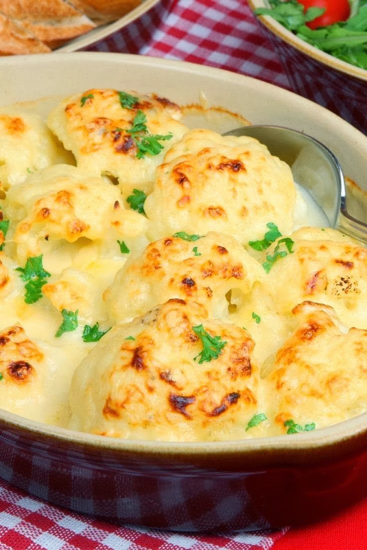 a casserole dish filled with cheese and garnished with parsley