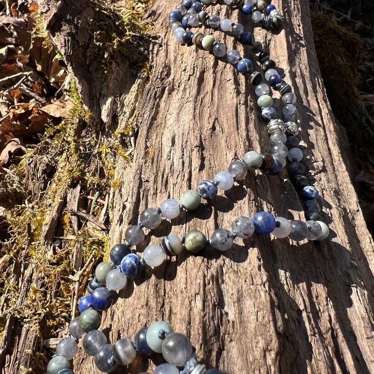 The Self Awareness Intention Necklace is made with Iolite, Eagle Eye, Sodalite, and Sardonyx stones along with a Blue Tigers Eye main focal stone. The unique combination of these powerful stones brings a sense of deep strength from within that allows you to trust your intuition and voice, along with a feeling of optimism and hope. Materials include: 6mm Iolite, Eagle Eye, Sodalite, and Sardonyx beads 42mm (1.75") Blue Tigers Eye focal stone 3.5" luxe, silky, deep blue tassel indigo colored C-Lon thread Necklace Length: 30" to main stone; 34.5" total. Necklace Length Guide Blue Tigers Eye is a symbol of strength. It calls on courage, deepens willpower, and helps those who wear it to overcome all kinds of challenges in their lives. Iolite has been used by shamans to enhance their ability to Sardonyx Stone, Trust Your Intuition, Necklace Length Guide, Thread Necklace, Symbols Of Strength, Blue Tigers, Indigo Colour, Eagle Eye, Blue Tassel