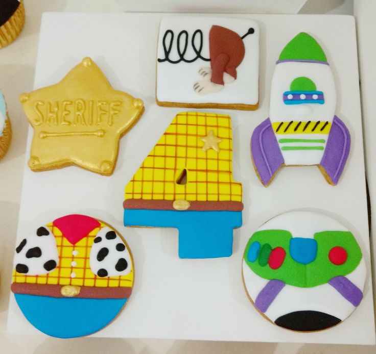 decorated cookies in the shape of airplanes and space shuttles