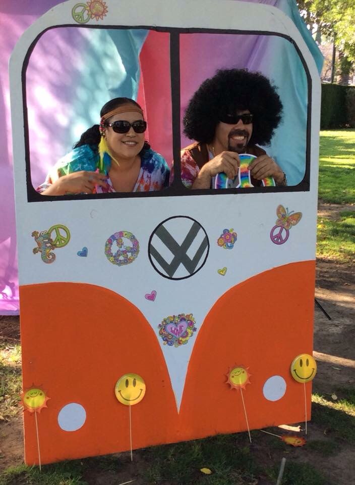 two people sitting in the back of a double decker bus with peace signs on it