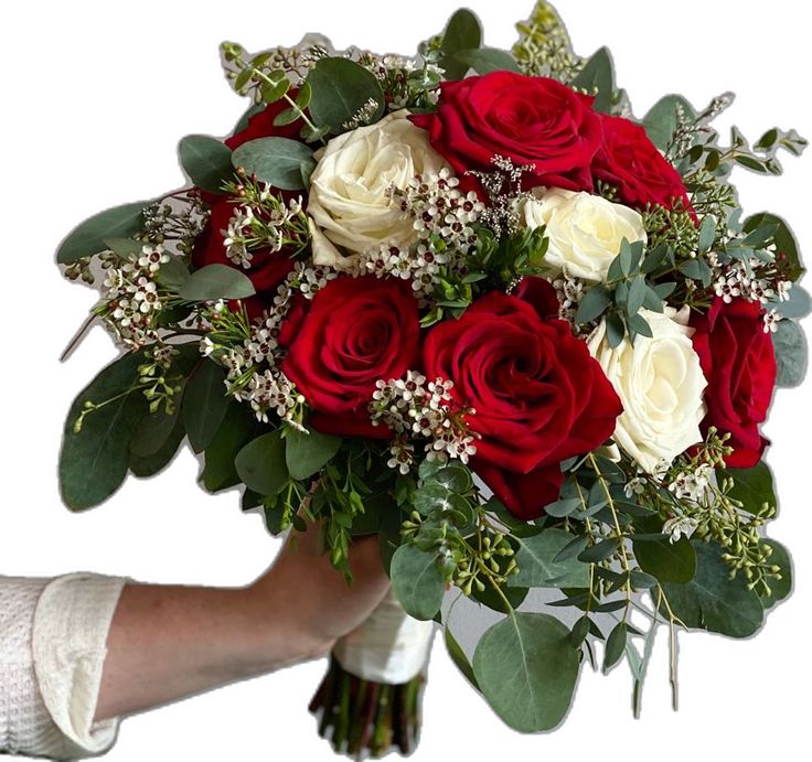 a bouquet of red and white roses in someone's hand