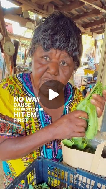 a woman is holding some lettuce in her hand