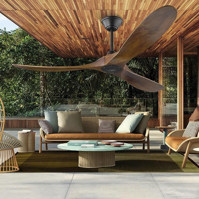 an outdoor living area with wicker furniture and a ceiling fan