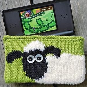 a cell phone case with a sheep design on the front and side, sitting on a wooden table