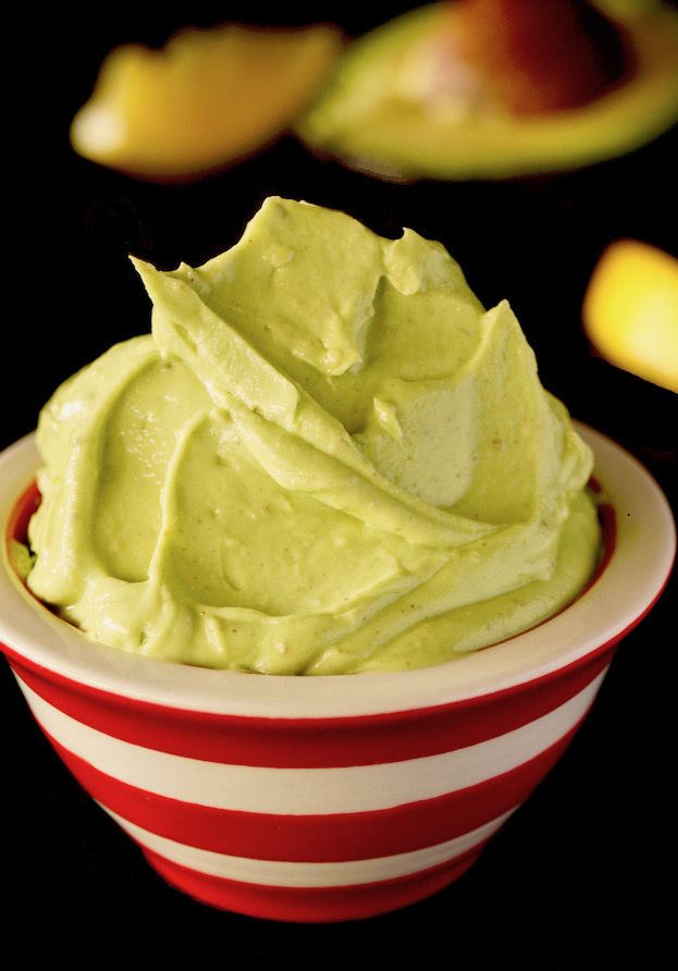 a red and white striped bowl filled with guacamole