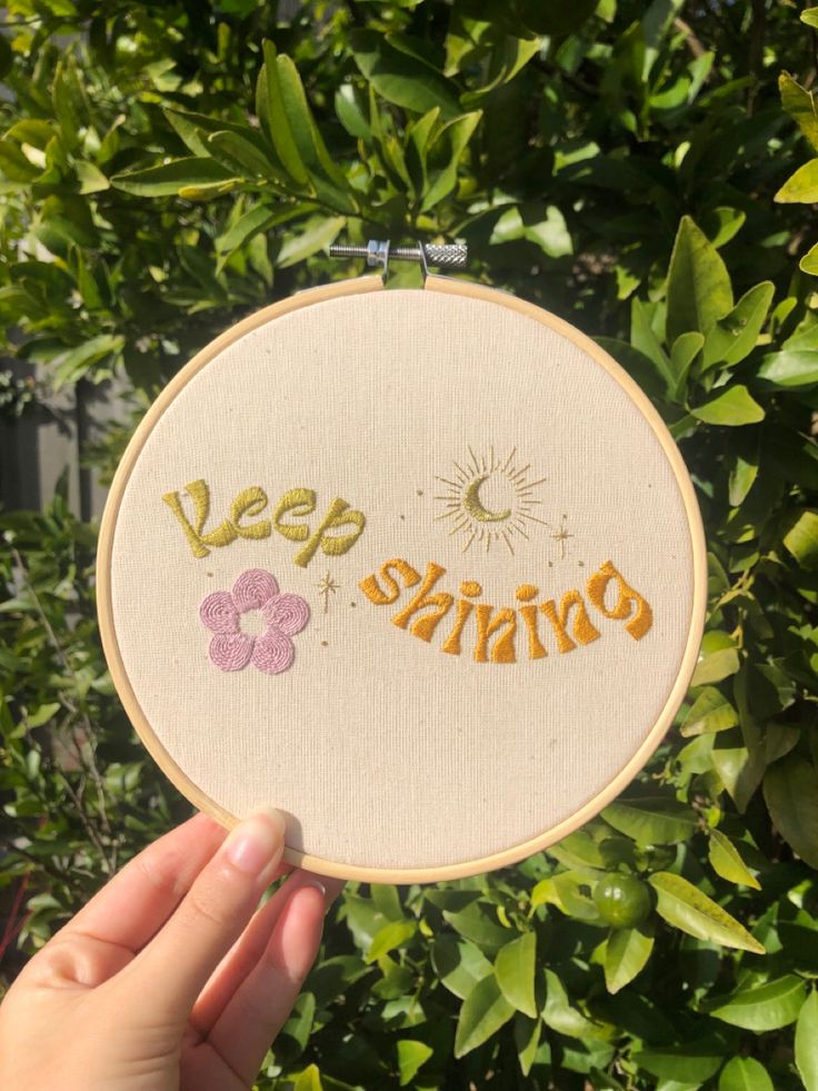 someone is holding up a small embroidery hoop with the words veep sunshine on it