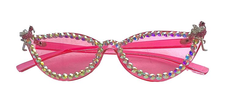 We are excited to announce the arrival of our latest product: pink flamingo bling sunglasses with a stunning flamingo jewel. These sunglasses are perfect for anyone looking to add a touch of fun and glam to their summer wardrobe. The pink frames are accented with shiny rhinestones and the flamingo jewel on the side adds a playful touch. These sunglasses provide both style and protection from the sun's harmful rays, making them a must-have accessory for any beach day or poolside party. Don't miss out on the chance to own these trendy and unique sunglasses! Pink Glass Sunglasses For Beach, Pink Glass Sunglasses For The Beach, Pink Cat Eye Sunglasses With Gradient Lenses For Party, Elegant Pink Sunglasses For Party, Elegant Pink Party Sunglasses, Pink Cat Eye Party Sunglasses, Party Pink Cat Eye Sunglasses, Party Cat Eye Sunglasses With Mirrored Lenses, Pink Cat Eye Sunglasses For Parties