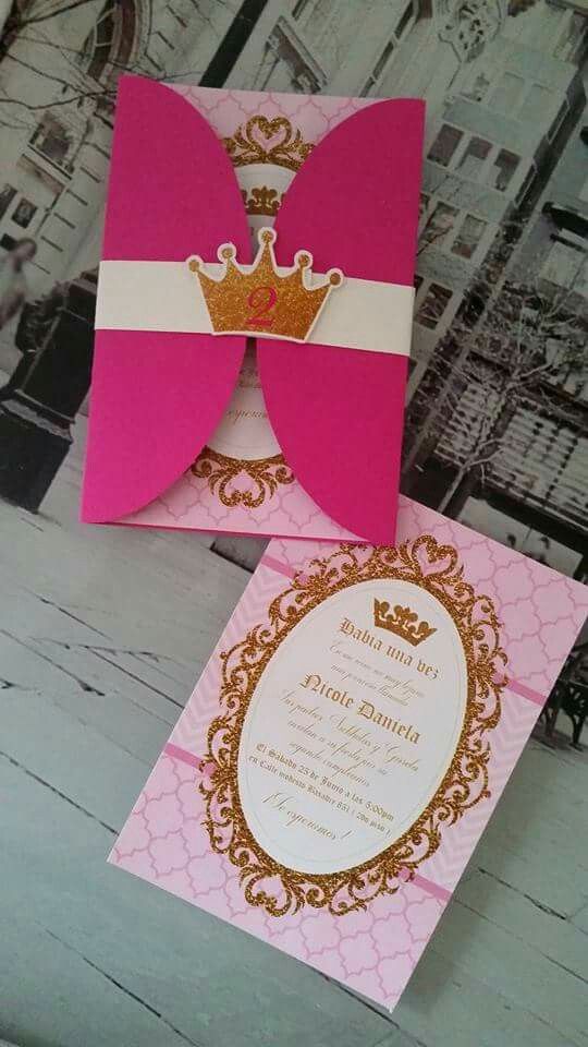 two pink and gold wedding cards with a crown on the front one has a white ribbon