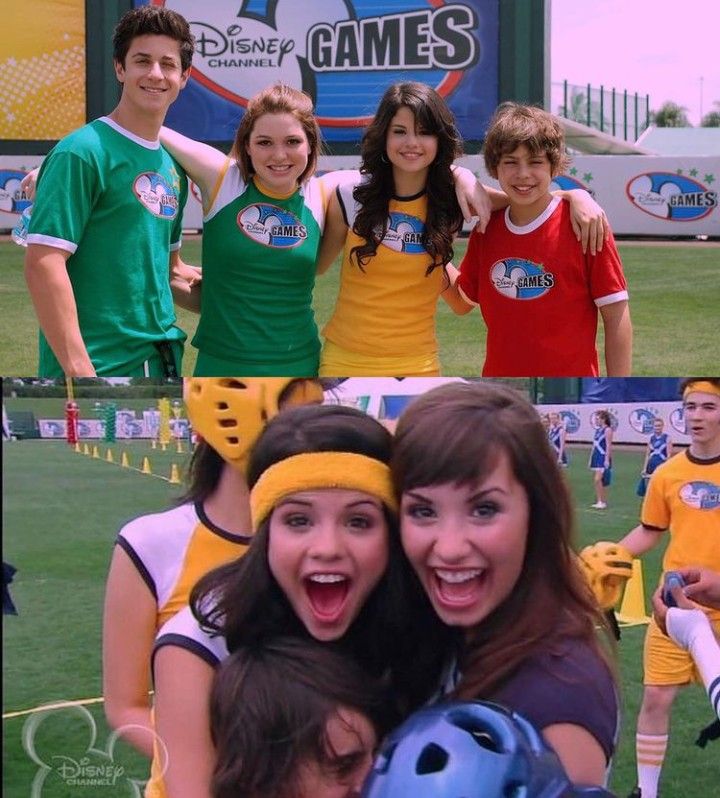 two girls and one boy are posing for the camera in front of a sports field