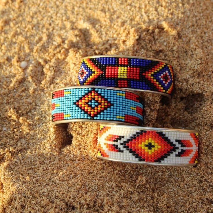 A metallic cuff with a beaded design in brilliant colors calling out a true southwest feel. Band is 2 3/8 inches in diameter, Cuff is approximately 1 inch wide. Beaded Bangles, Loom Designs, Seed Bead Jewelry Patterns, Beaded Hair Clips, Bead Loom Designs, Beaded Bangles Bracelets, Beaded Hair, Beadwork Designs, Land Of Enchantment