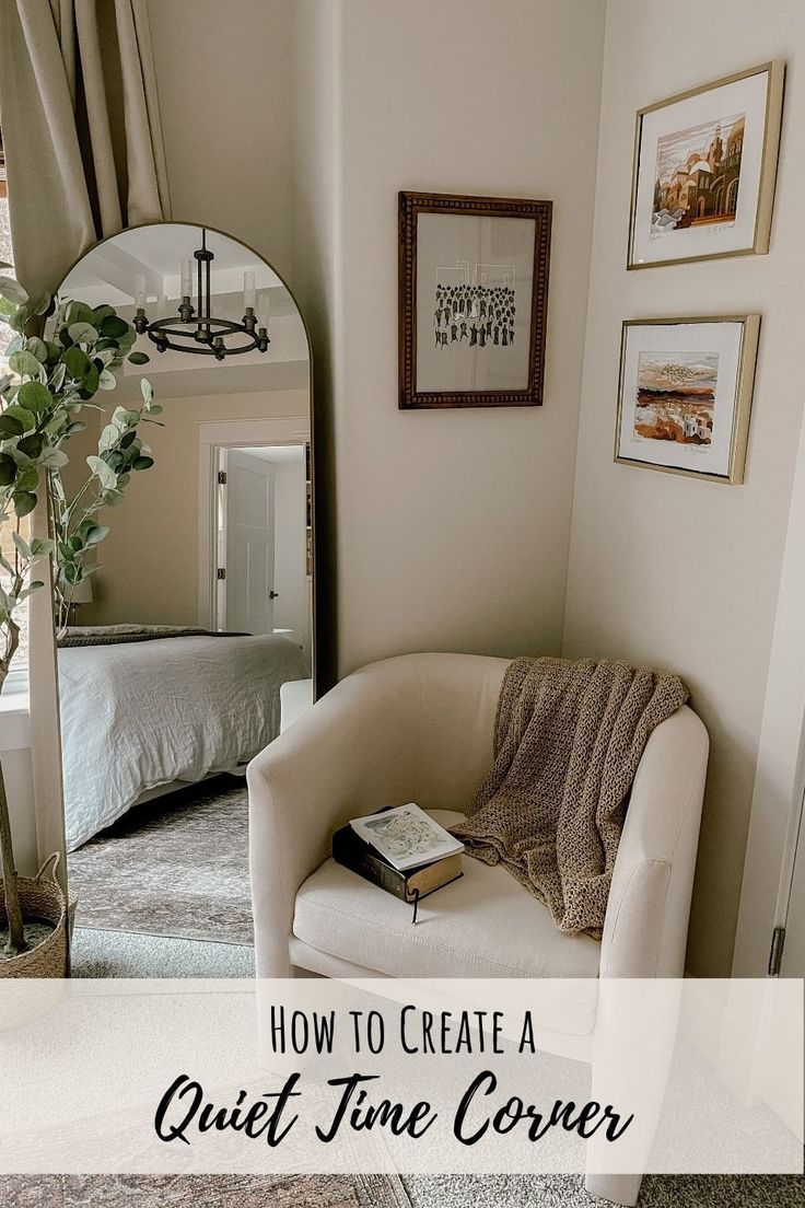 a chair with a book on it in front of a mirror and pictures above the couch