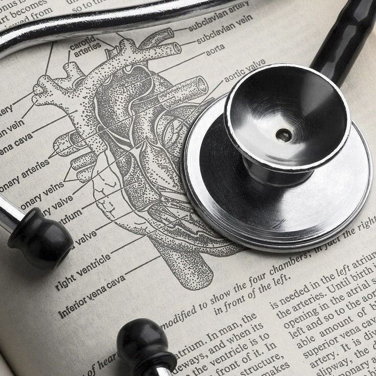 a stethoscope laying on top of an open book