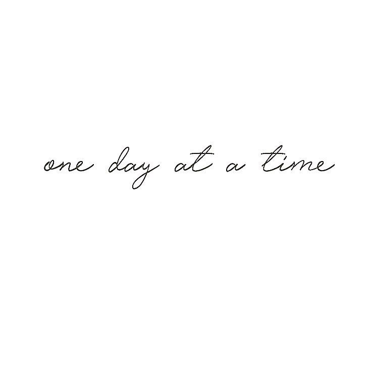 the words one day at a time written in cursive handwriting on a white background