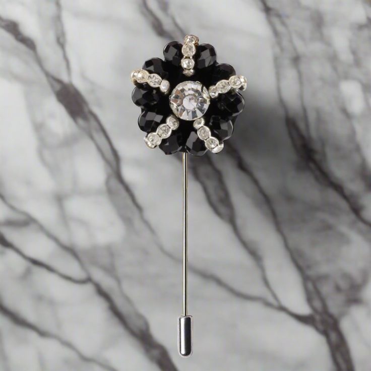 A zinc alloy lapel pin with black and clear stones is a stylish and sophisticated accessory that is perfect for formal occasions. The pin features a sleek and modern design, with a combination of black and clear stones set in a polished zinc alloy base. The black stones are made of high-quality cubic zirconia, and are set in a distinctive pattern that adds depth and texture to the pin. The clear stones, on the other hand, are usually small and subtle, and are used to accentuate the black stones Classic Black Lapel Pin For Formal Occasions, Black Brooch Pins For Evening, Elegant Crystal Pins For Party, Black Formal Brooch Lapel Pin, Classic Black Brooches For Formal Occasions, Classic Black Formal Brooches, Black Formal Lapel Brooch, Black Brooch Pins For Party, Black Brooch For Formal Occasions