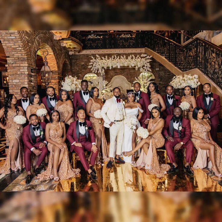 a large group of people in formal wear posing for a photo