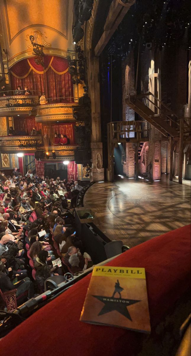 an auditorium full of people sitting in seats