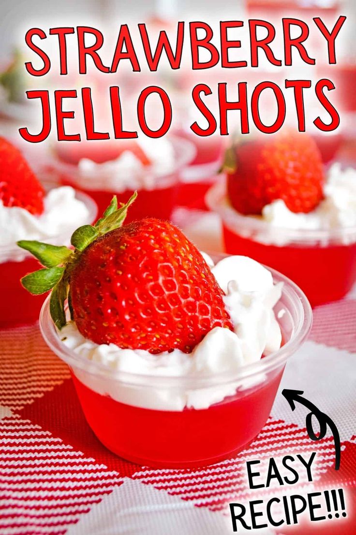 strawberry jello shots in plastic cups with whipped cream on top