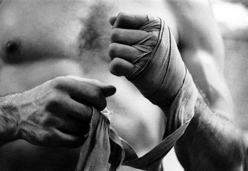 black and white photograph of a man's arm wrapped in bandages