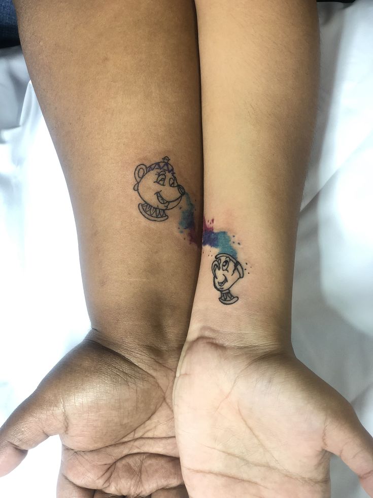 two people with matching tattoos on their arms