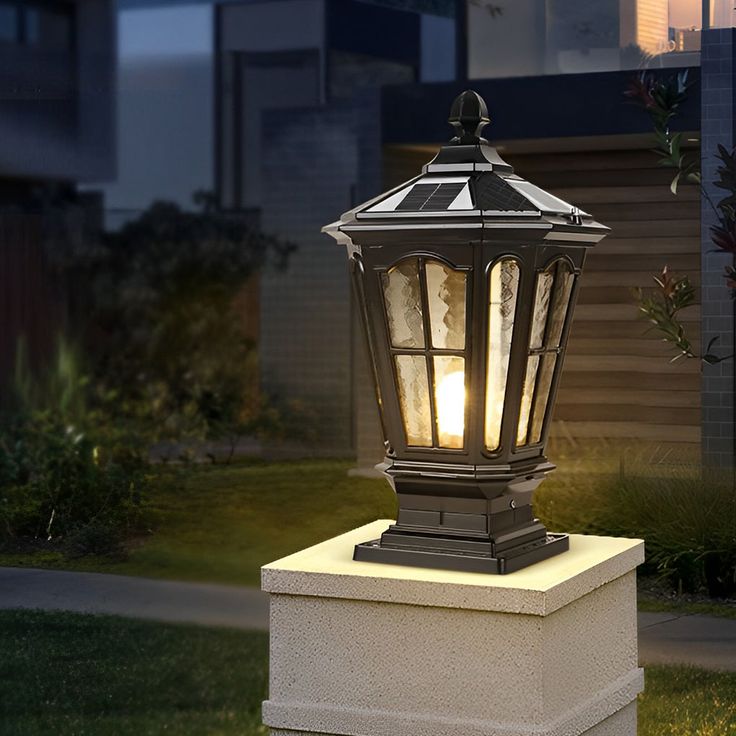 an outdoor light on top of a cement block