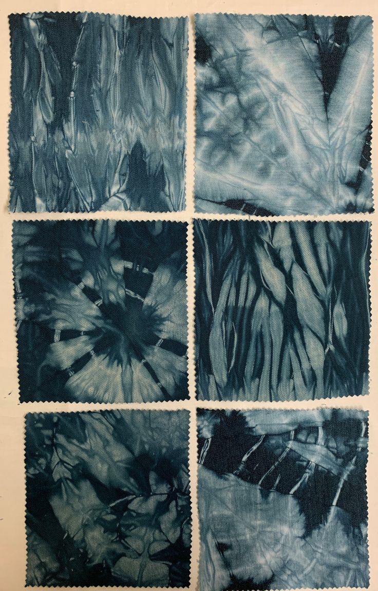 four squares of blue and black fabric with white stitchs on the edges, each showing different patterns