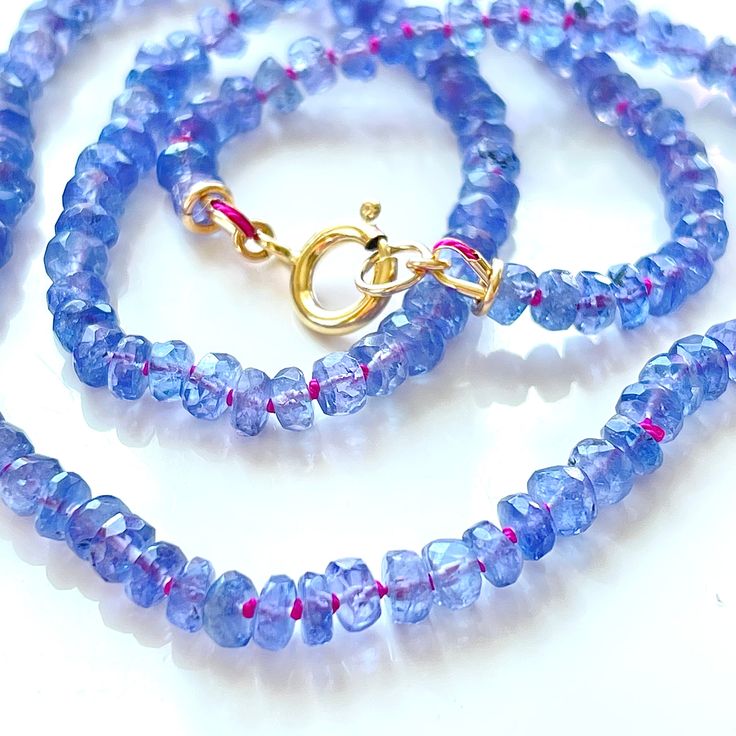 I looooooooove Tanzanite. One of my all time favorite stones. It looks good with pretty much any precious or semi-precious gemstone and it's delightfully sparkly.  . This necklace is made from natural Tanzanite gemstones that I've knotted on hand-dyed silk cord and finished with 14/20 gold fill findings. The beads in the necklaces knotted on rainbow are between 3.5mm and 4mm in size, and the necklaces on Fuchsia silk have a bit more graduation from about 3mm at the smallest to 4mm at the largest Gemstone Rondelle Jewelry Gift, Rondelle Crystal Necklaces With Natural Stones For Gifts, Adjustable Gemstone Rondelle Necklaces, Adjustable Rondelle Gemstone Necklace, Briolette Tanzanite Necklace For Gift, Tanzanite Briolette Necklace Gift, Tanzanite Briolette Gemstone Necklace, Gemstone Rondelle Necklaces For Gifts, Gemstone Rondelle Necklace For Gift