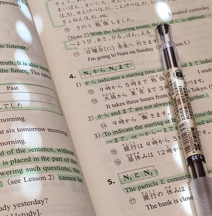 a pen sitting on top of an open book next to it's page numbers