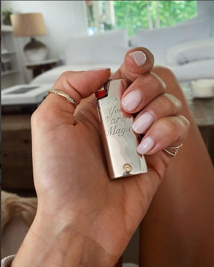 a woman is holding a lighter in her hand