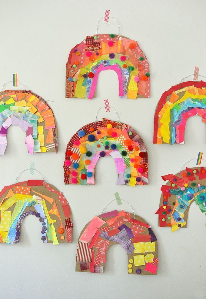 several pieces of paper cut out to look like rainbows and arches are hanging on the wall