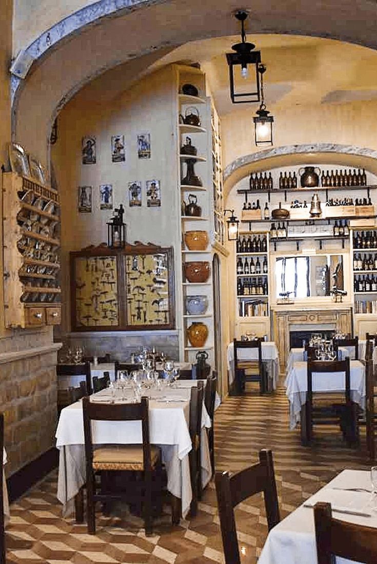 the inside of a restaurant with tables and chairs set up for two people to eat