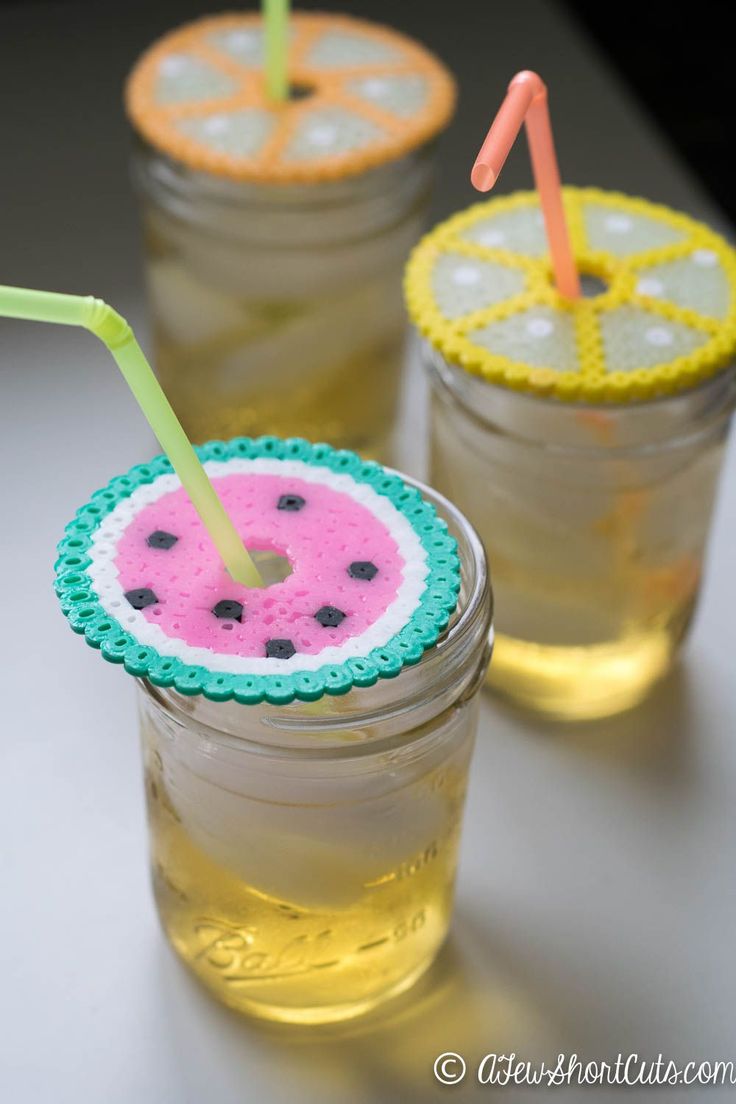 three mason jars filled with watermelon and lemonade drink garnishes