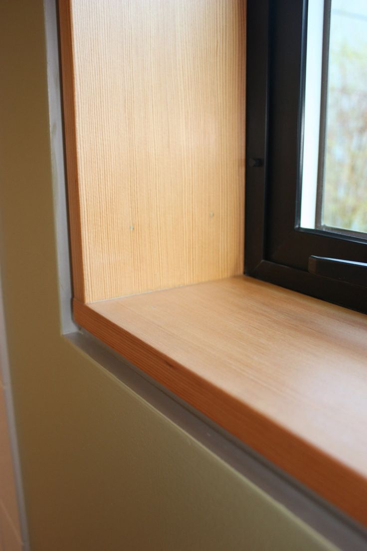 an empty window sill in front of a white wall