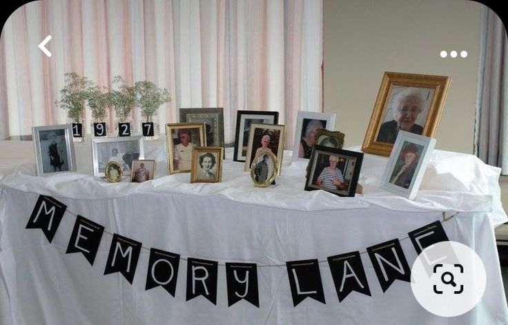 a table topped with pictures and framed photos