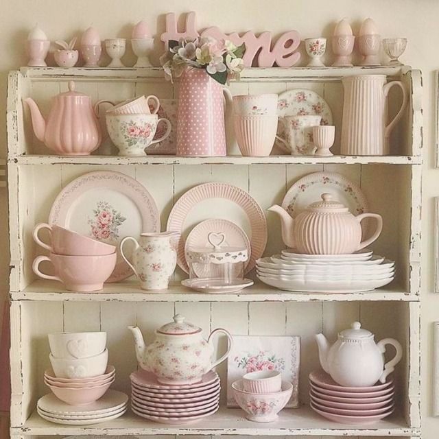 a shelf filled with lots of pink and white dishes