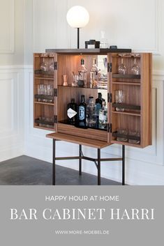 a bar cabinet with bottles and glasses on it