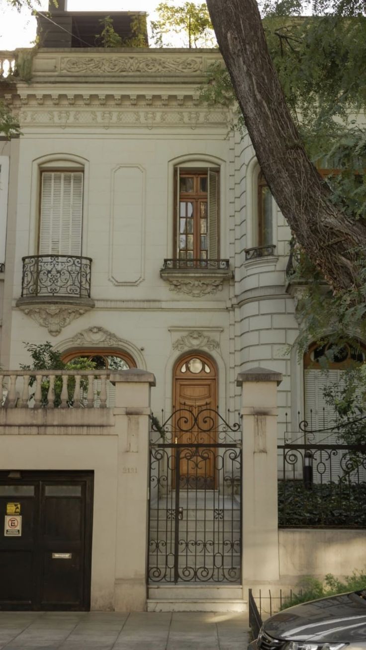 a large white house with an iron gate