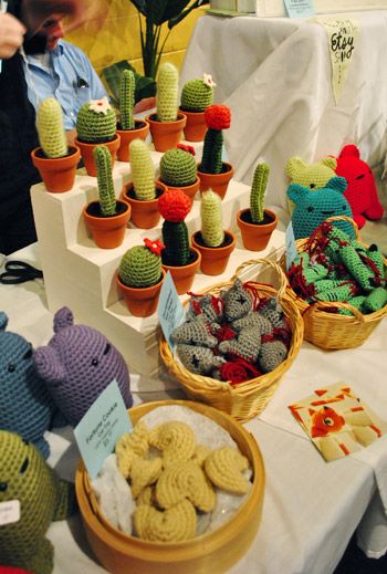 a table topped with lots of stuffed animals and cactus plants