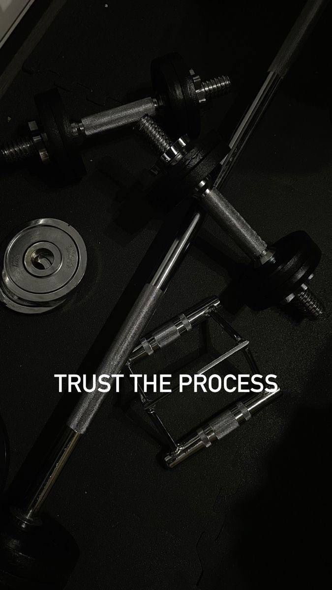 the words trust the process are displayed in front of an image of two dumbbells