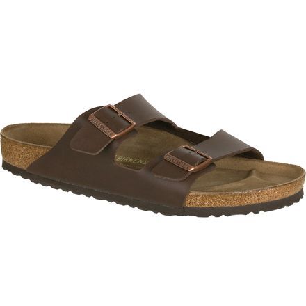 After a long morning hike, nothing feels better than to get back to camp, take off your heavy hiking boots, and slip on the Birkenstock Men's Arizona Sandal. Better than going barefoot, this sandal's contoured cork footbed conforms to the shape of your foot while protecting your foot from rocks and thorns as you walk from your tent to the lake for a late lunch overlooking the water. The durable synthetic straps are finished with a leather-like texture for classic style, while the buckled design Leather Sandals With Cork-bed Midsoles For Outdoor Activities, Rugged Outdoor Sandals With Cushioned Footbed, Comfortable Brown Sandals For Outdoor Activities, Comfortable Sandals With Leather Footbed For Outdoor, Comfortable Leather Footbed Sandals For Outdoor, Brown Sandals With Arch Support For Outdoor Activities, Brown Sandals With Arch Support For Outdoor, Brown Sandals With Leather Footbed For Outdoor, Sandals With Cork-bed Midsoles For Outdoor Activities